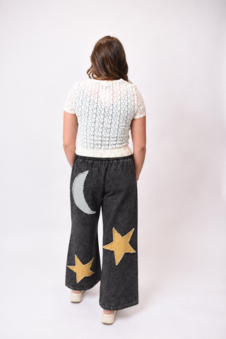 Back view of model wearing black celestial pants
